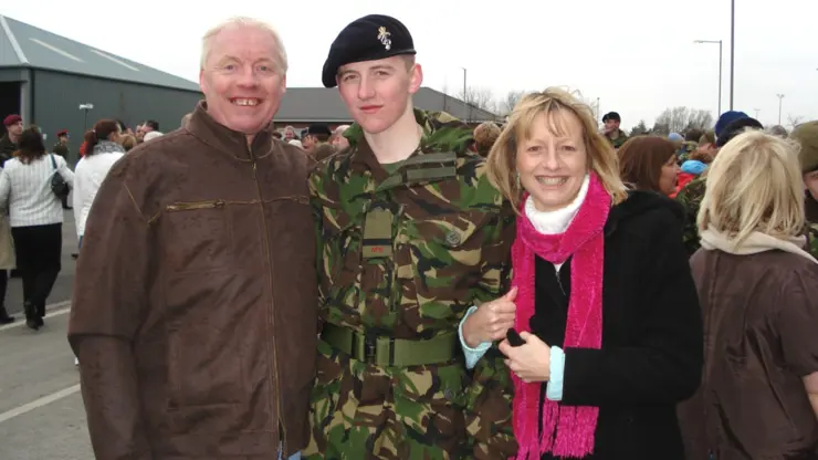 Tom Benson (middle) during his time at the British Army with his family.